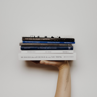 hand-holding-multiple-books-like-sandwhich