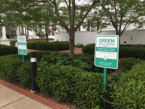 sidewalk with green sign